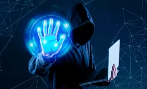 a person in a hoodie holding a laptop and a glowing hand